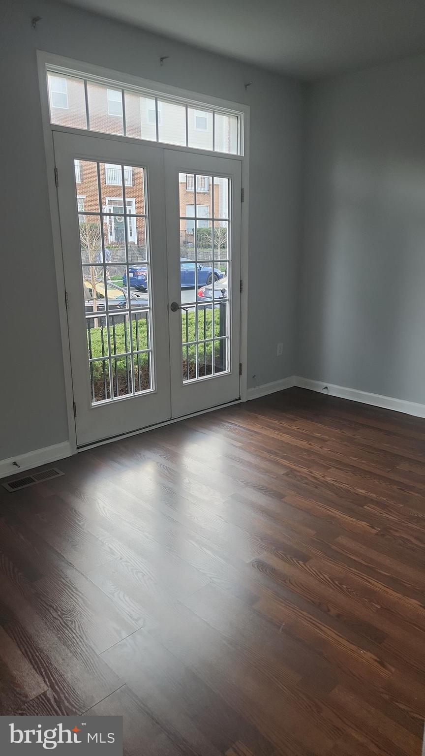 11612 Leesborough Circle Silver Spring, MD 20902 - Photo 8 of 29 an empty room with wooden floor and windows