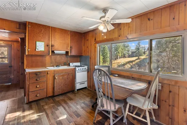 a kitchen with a table chairs refrigerator and cabinets