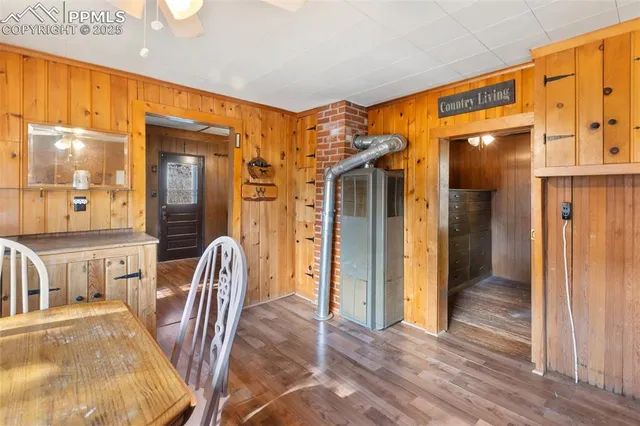 a view of a hallway with furniture and wooden floor