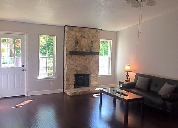 3305 Spaniel Drive Austin, TX 78759 - Photo 15 of 20 Rich hardwood floors welcome you to a living area anchored by a stately stone fireplace.