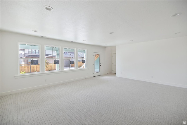 7189 South Sage Road, Unit 214 West Jordan, UT 84081 - Photo 25 of 29 Spacious room featuring light-colored carpet, recessed ceiling lighting, and a series of four large windows