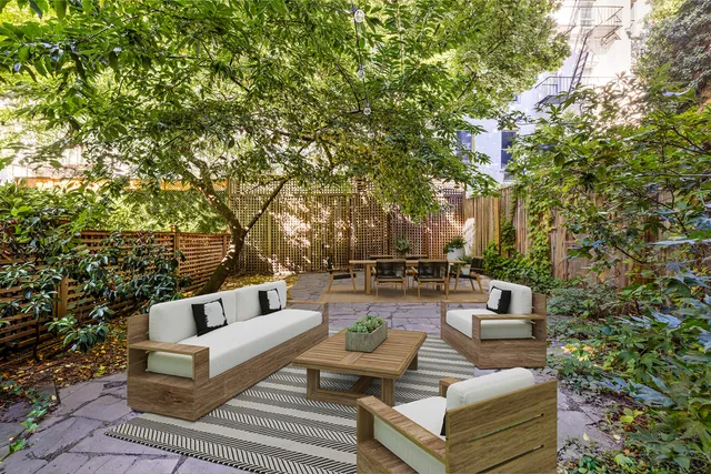 a view of a patio with couches and a large tree
