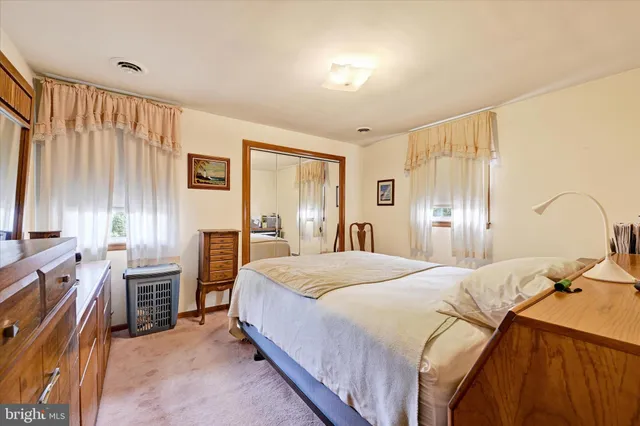 a bedroom with a bed dresser and a window