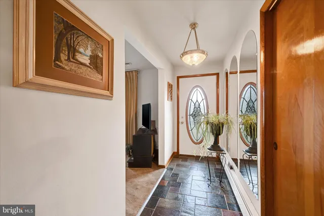 a view of an entryway with wooden floor