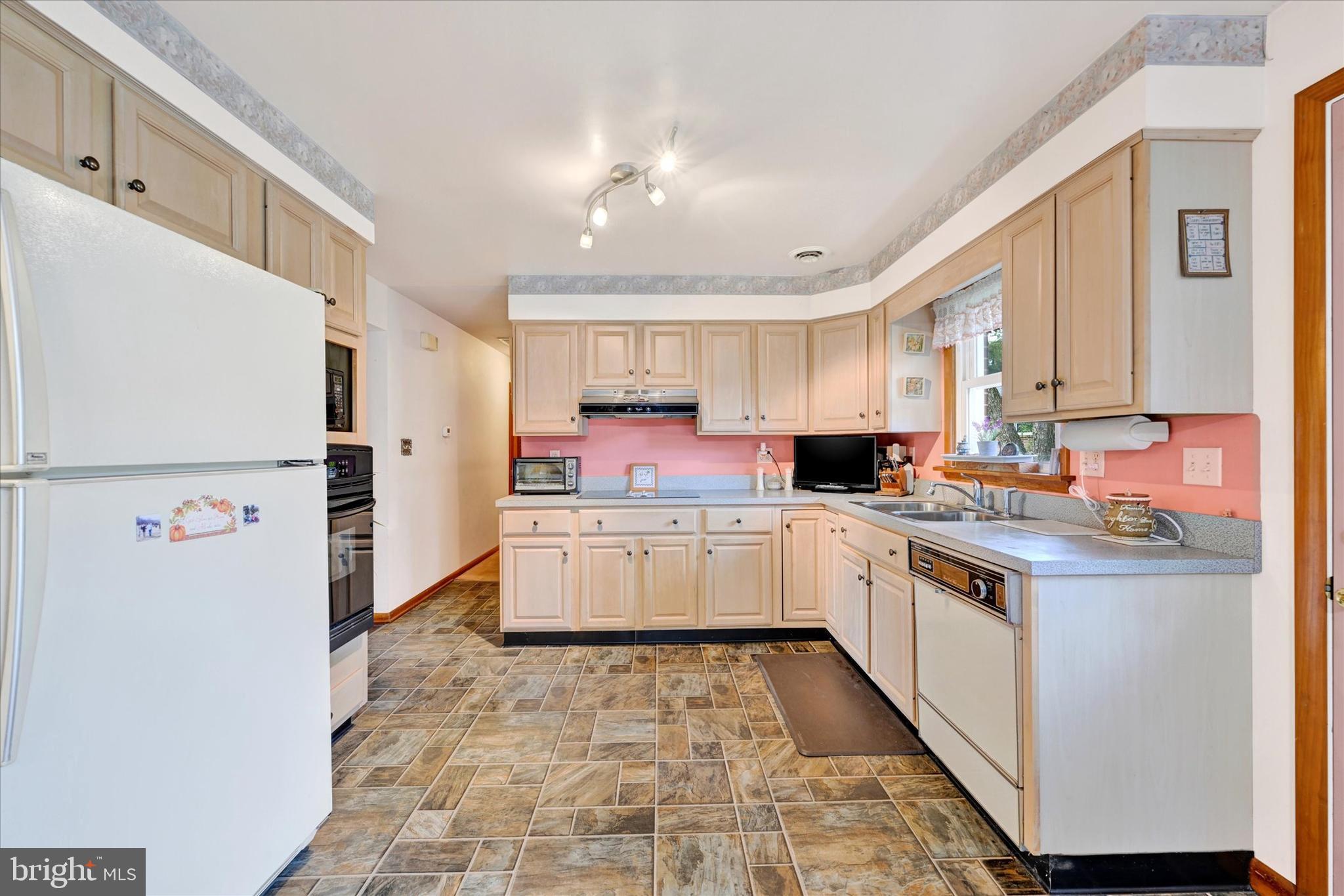 700 Remington Road Fallston, MD 21047 - Photo 6 of 42 a kitchen with a refrigerator a sink and cabinets