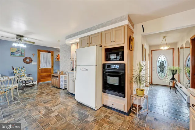 a kitchen with stainless steel appliances a refrigerator and a stove top oven
