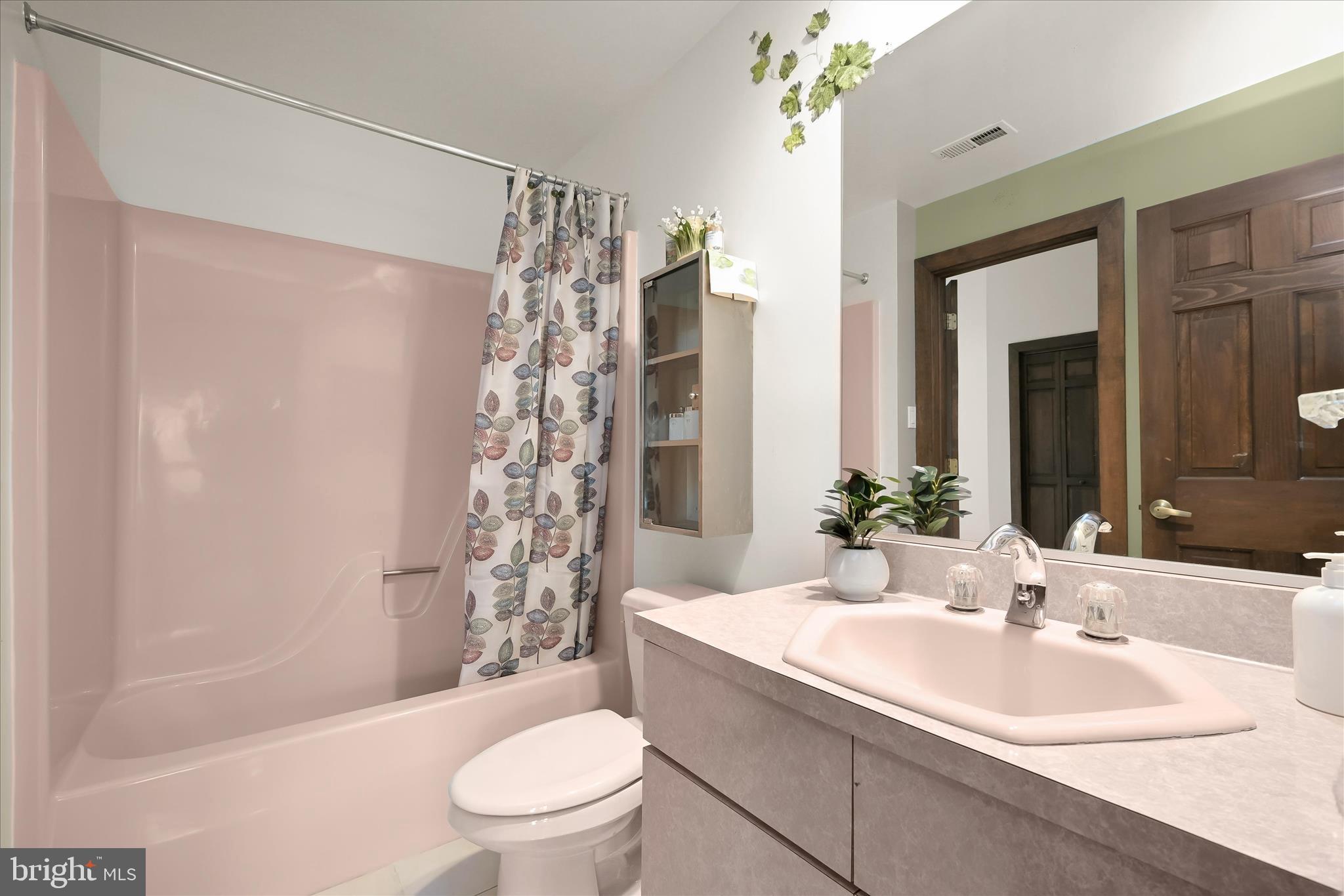 13304 Ridgewood Drive Ellicott City, MD 21042 - Photo 56 of 95 a bathroom with a granite countertop sink toilet and shower