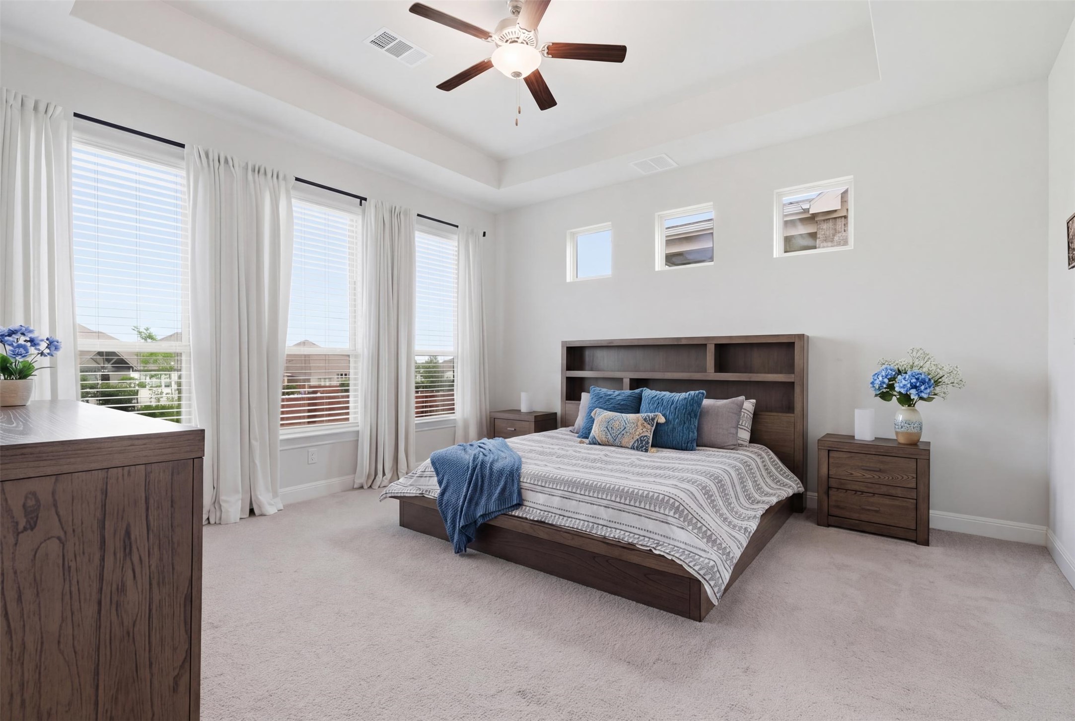 118 Bear Paw Run Georgetown, TX 78628 - Photo 14 of 35 Spacious bedroom featuring light-colored carpet, a ceiling fan, and large windows with blinds