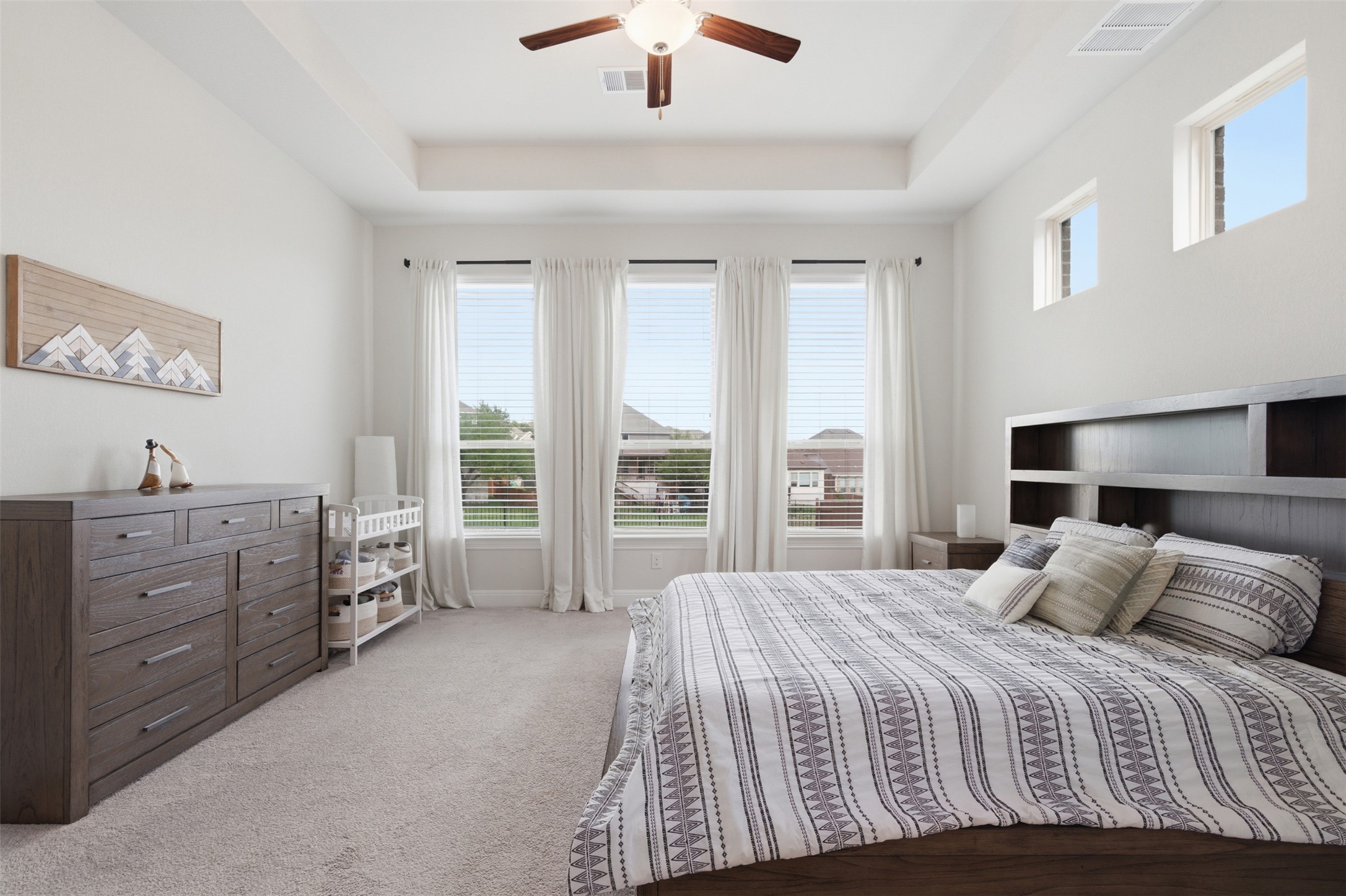 118 Bear Paw Run Georgetown, TX 78628 - Photo 15 of 35 The room features a tray ceiling, a ceiling fan, and carpeted flooring