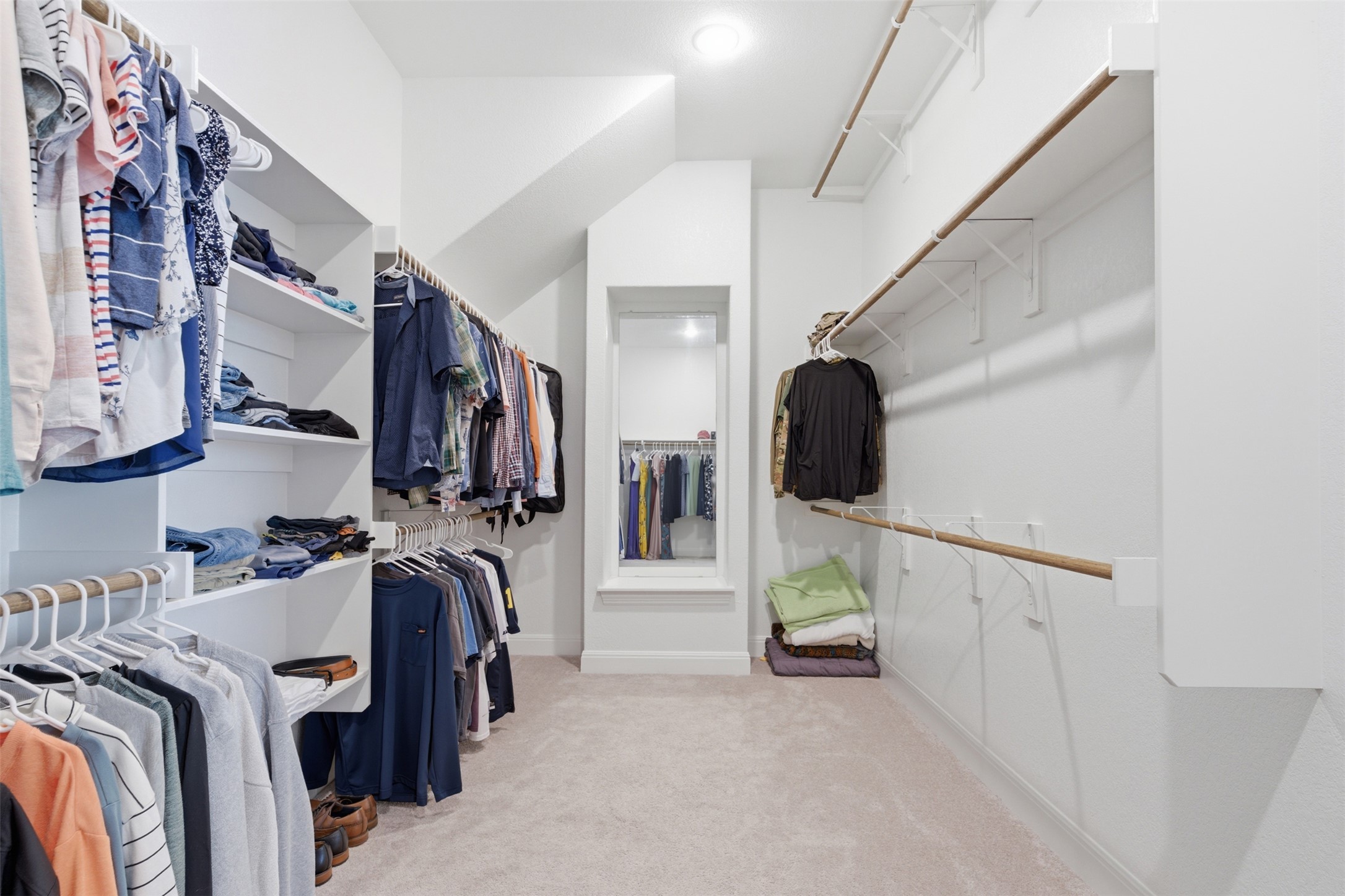 118 Bear Paw Run Georgetown, TX 78628 - Photo 16 of 35 Spacious walk-in closet featuring white built-in shelving, hanging rods, and light-colored carpeting
