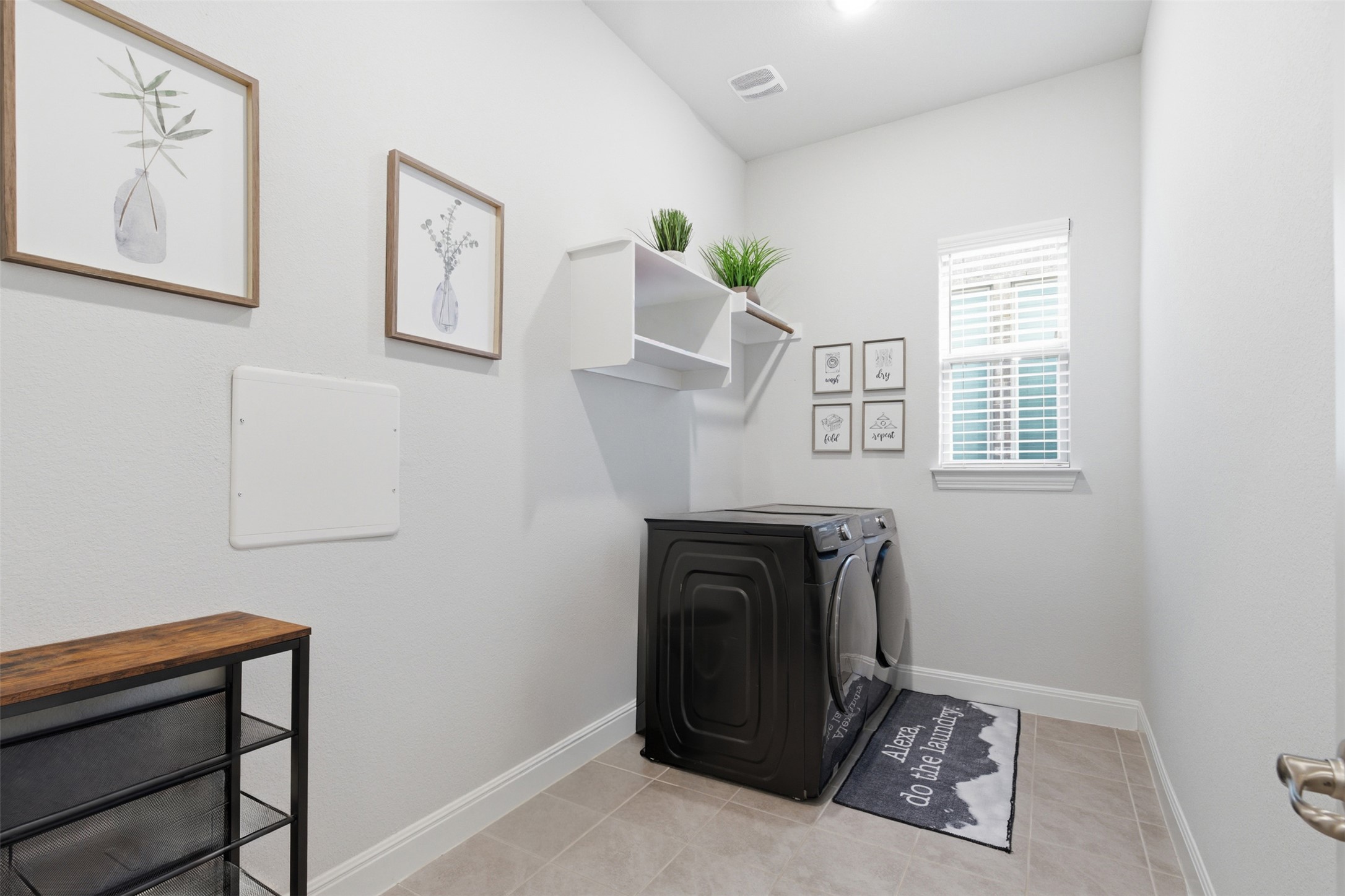 118 Bear Paw Run Georgetown, TX 78628 - Photo 23 of 35 Laundry room with tile flooring, a window providing natural light, and built-in shelving