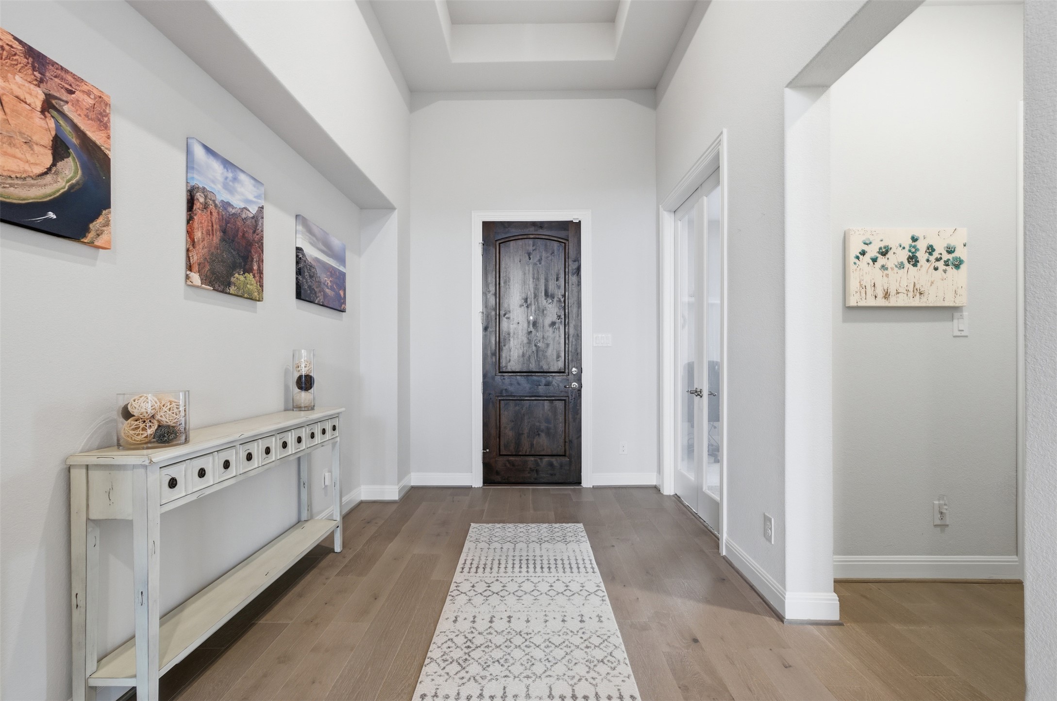 118 Bear Paw Run Georgetown, TX 78628 - Photo 4 of 35 The entry features hardwood floors, a coffered ceiling, and a dark wood front door