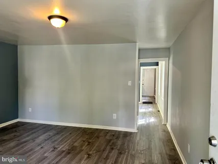a view of a room with wooden floor