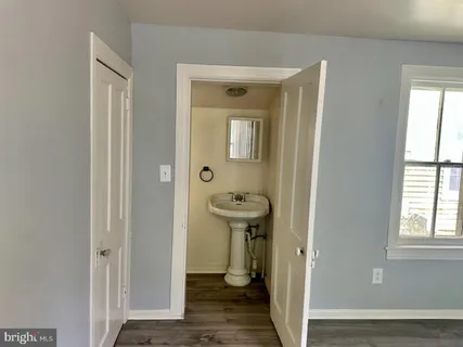 a bathroom with a sink a toilet and a window
