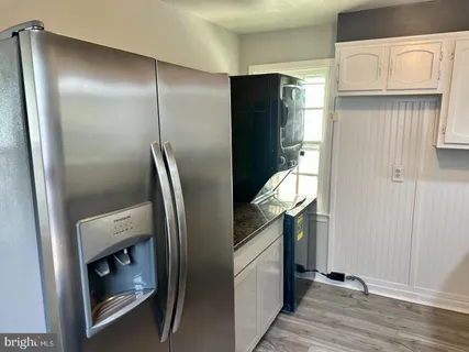 a metallic refrigerator freezer sitting in a kitchen