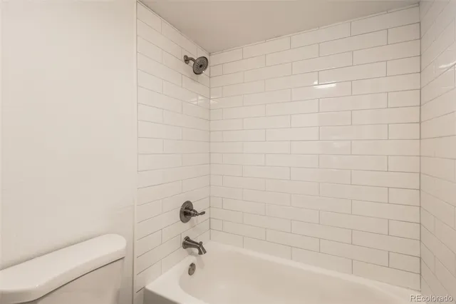 a bathroom with a bathtub and toilet