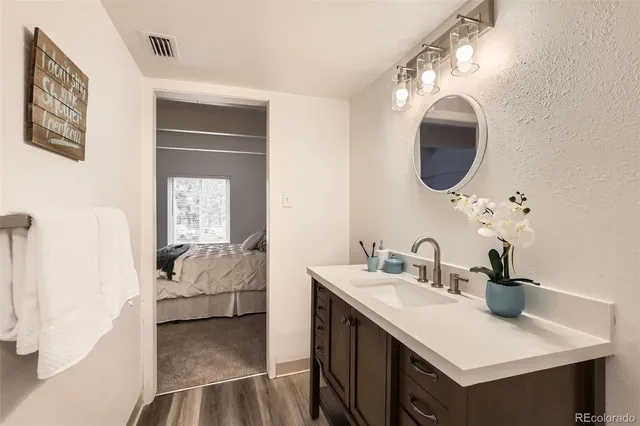 a en suite bathroom with a double vanity sink and a mirror