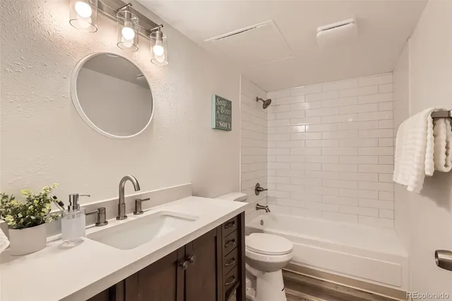a bathroom with a double vanity sink toilet and shower