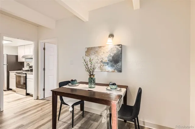 a view of a dining room with furniture and wooden floor