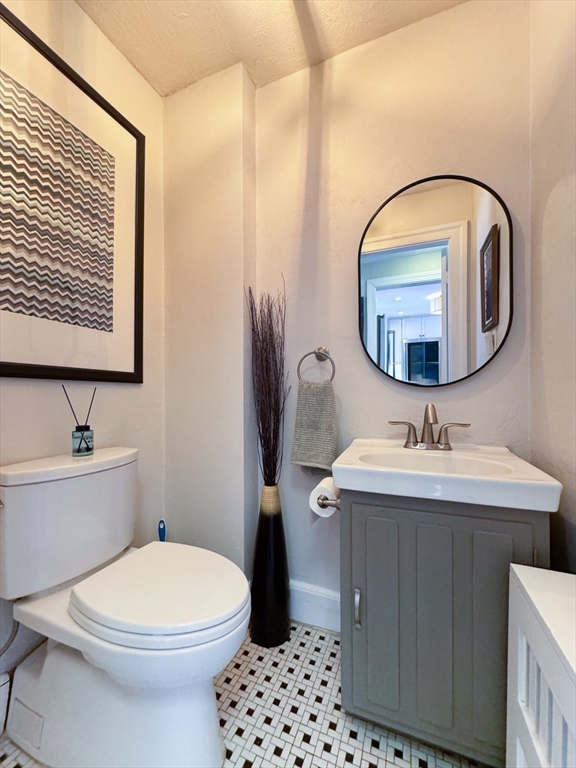 40 Waldorf Road Newton, MA 02461 - Photo 13 of 29 a bathroom with a toilet a sink and mirror