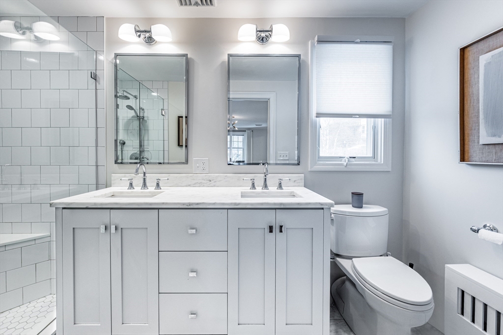 40 Waldorf Road Newton, MA 02461 - Photo 17 of 29 a bathroom with a toilet sink and mirror