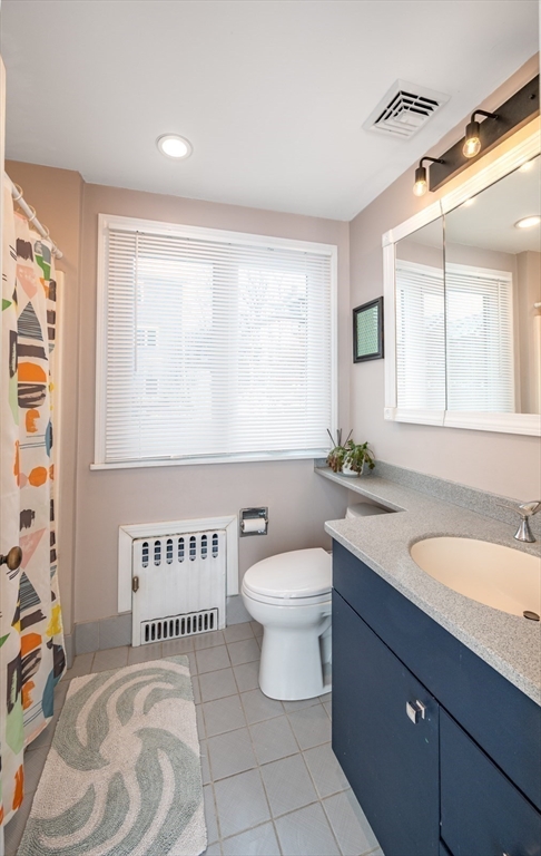 40 Waldorf Road Newton, MA 02461 - Photo 20 of 29 a bathroom with a granite countertop sink mirror vanity and a toilet