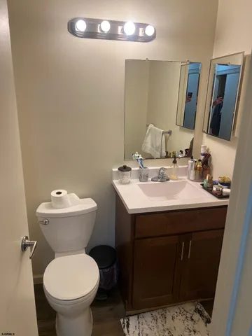 a bathroom with a sink toilet and mirror