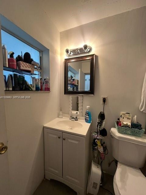7230 Northwest 3rd Street Miami, FL 33126 - Photo 16 of 28 a bathroom with a toilet a sink and mirror