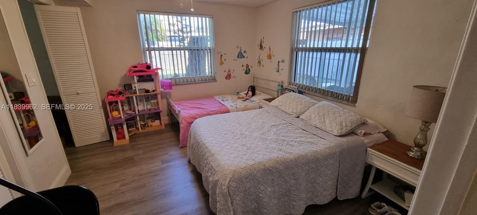 7230 Northwest 3rd Street Miami, FL 33126 - Photo 5 of 28 a bedroom with a bed and a window