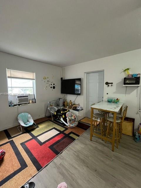 7230 Northwest 3rd Street Miami, FL 33126 - Photo 8 of 28 a living room with furniture a wooden floor and a flat screen tv