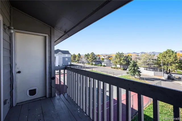 a view of a balcony with wooden floor