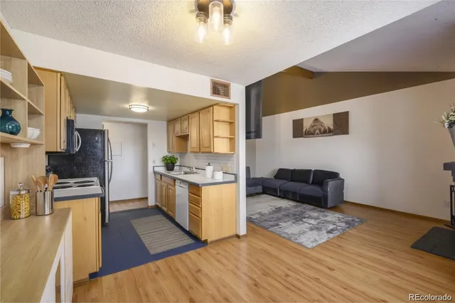 a kitchen with a sink and a stove top oven