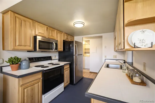 a kitchen with a sink a stove and cabinets