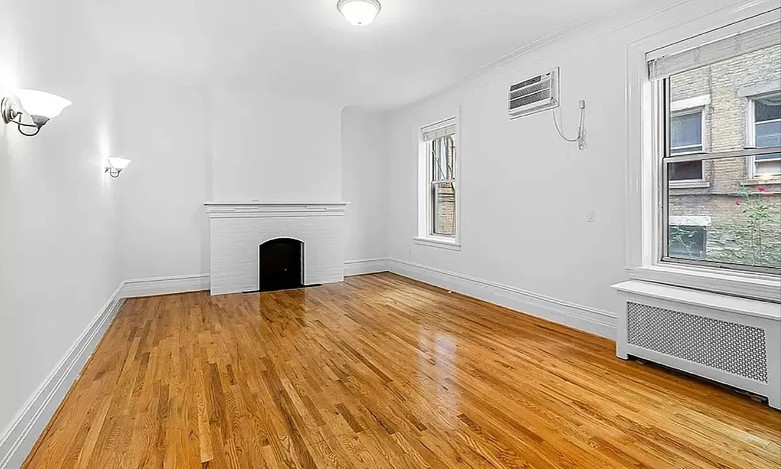77 West 85th Street, Unit 1C Manhattan, NY 10024 - Photo 2 of 10 a view of empty room with fireplace and wooden floor