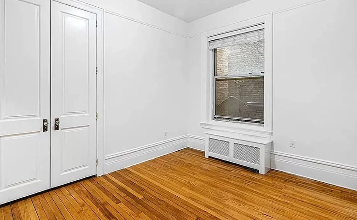 77 West 85th Street, Unit 1C Manhattan, NY 10024 - Photo 4 of 10 a view of empty room with wooden floor and fan