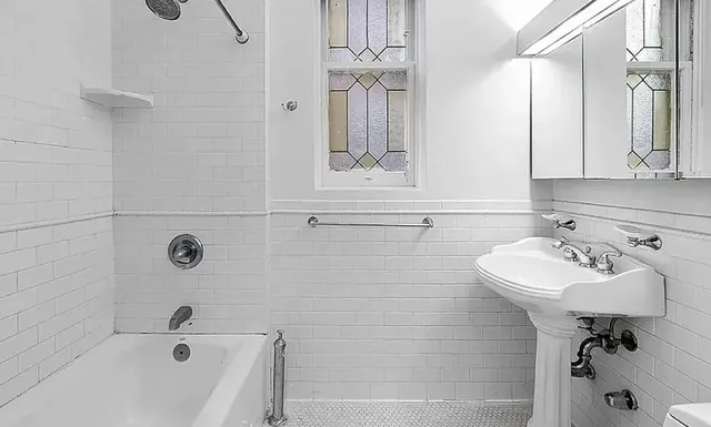 a bathroom with a sink a toilet and bathtub
