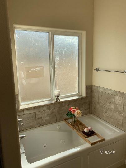 425 Randall Street Ridgecrest, CA 93555 - Photo 23 of 27 a bath tub sitting next to a bathroom sink
