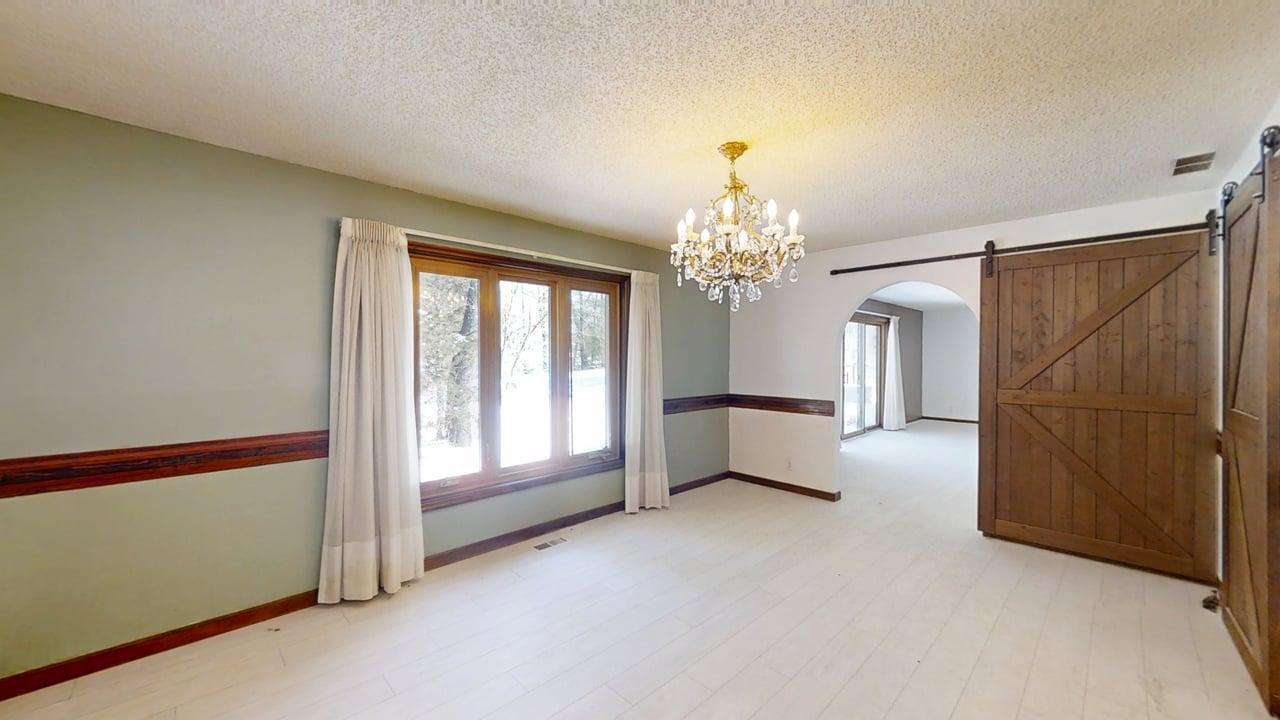 1756 West Ravina Park Road Decatur, IL 62526 - Photo 11 of 47 a view of a big room with windows and chandelier