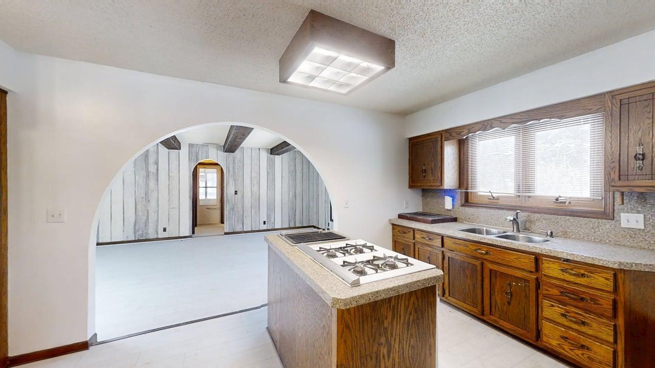1756 West Ravina Park Road Decatur, IL 62526 - Photo 13 of 47 a kitchen with a stove a sink and a refrigerator
