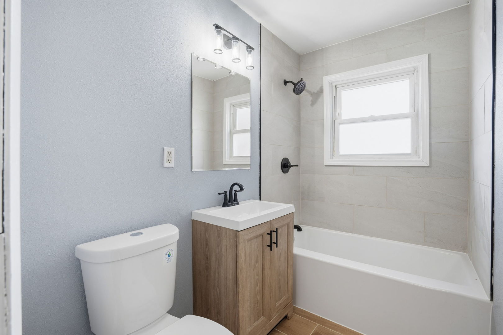 2515 West 69th Street Davenport, IA 52806 - Photo 12 of 15 a bathroom with a sink a toilet and a bathtub