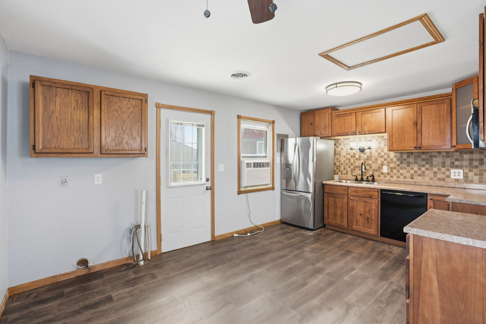2515 West 69th Street Davenport, IA 52806 - Photo 5 of 15 a kitchen with refrigerator cabinets and wooden floor