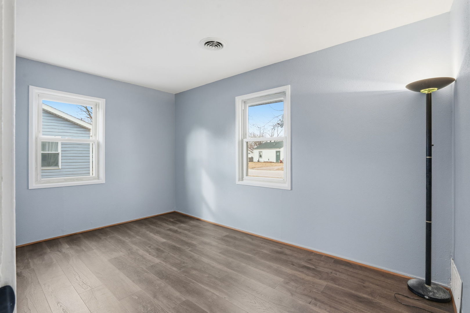 2515 West 69th Street Davenport, IA 52806 - Photo 8 of 15 a view of an empty room with a window and wooden floor