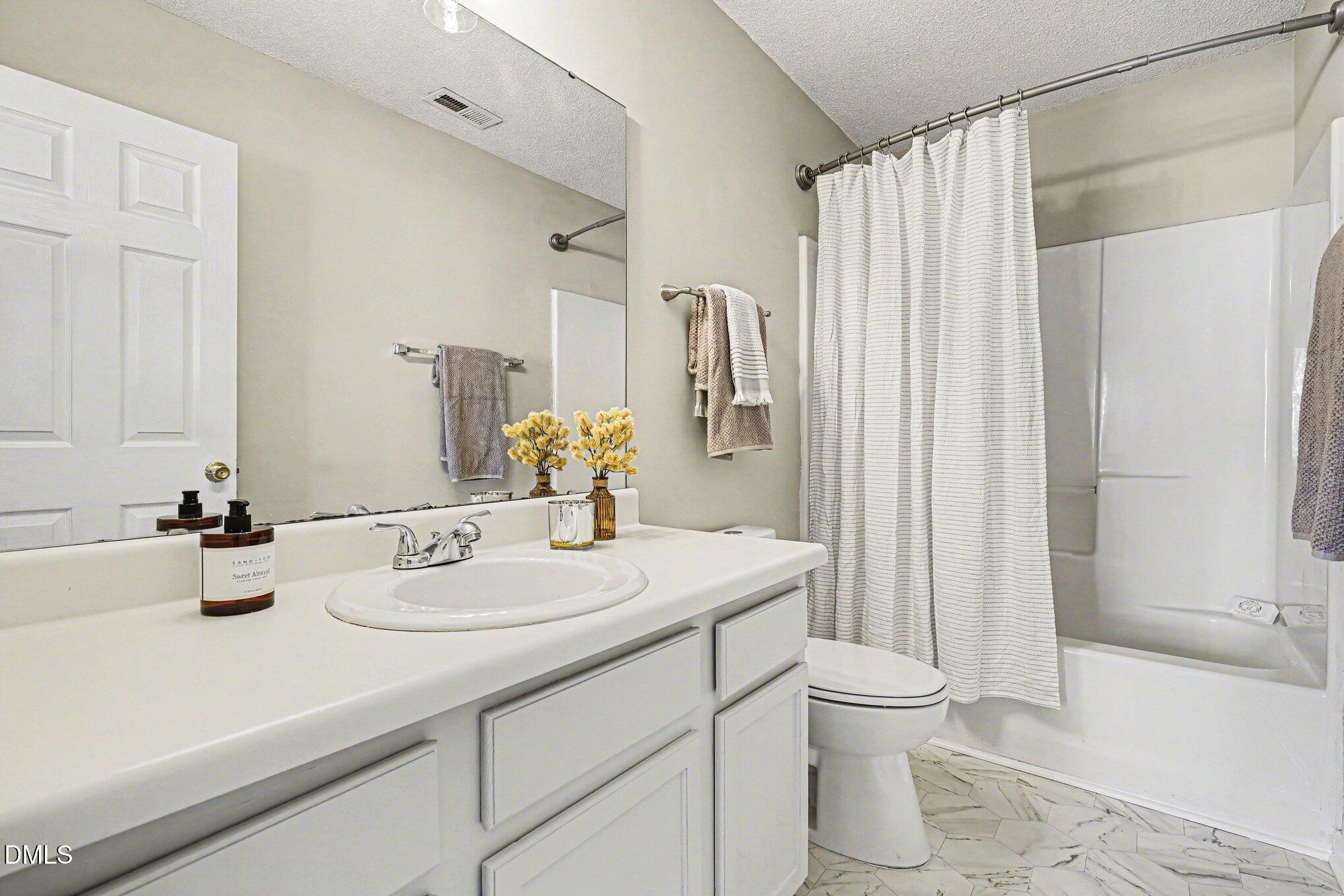9904 Treymore Drive Raleigh, NC 27617 - Photo 16 of 33 a bathroom with a sink toilet and shower