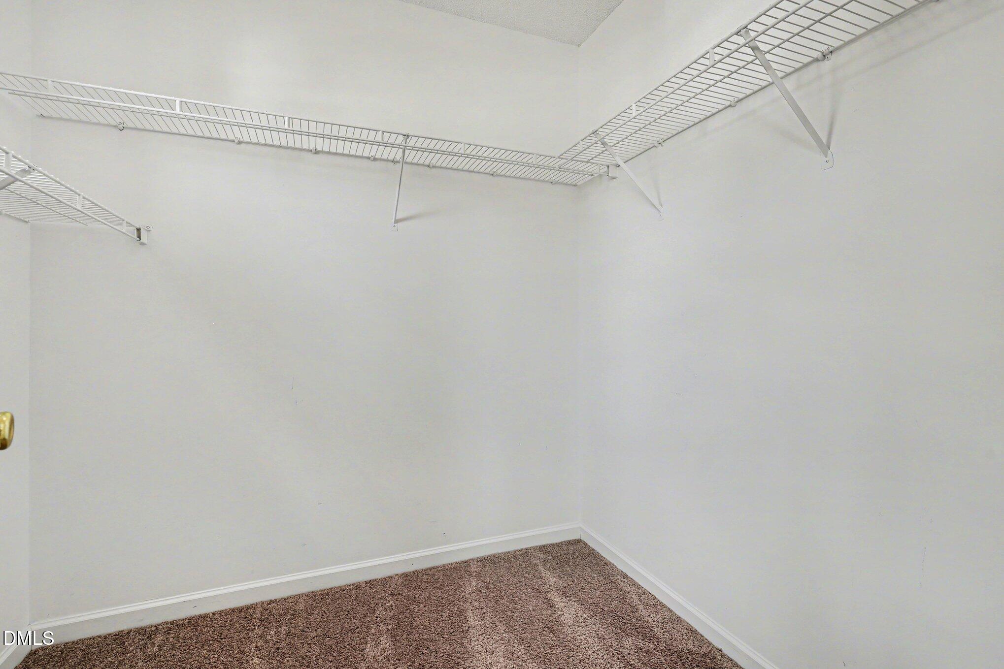 9904 Treymore Drive Raleigh, NC 27617 - Photo 17 of 33 a view of a room with racks on the wall