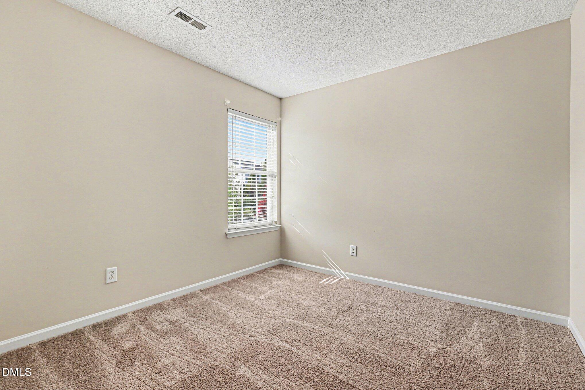 9904 Treymore Drive Raleigh, NC 27617 - Photo 19 of 33 an empty room with windows
