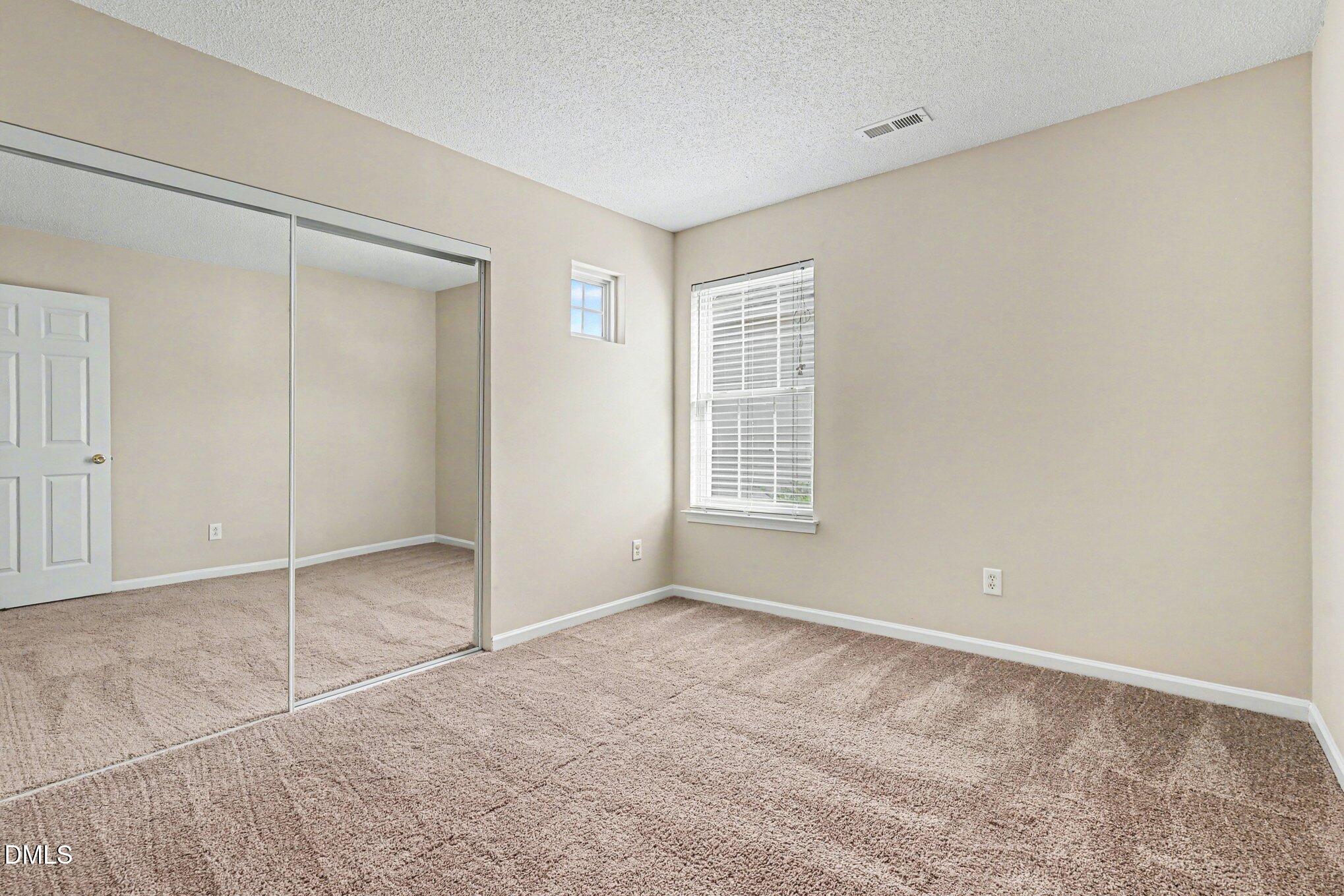 9904 Treymore Drive Raleigh, NC 27617 - Photo 21 of 33 an empty room with windows and closet