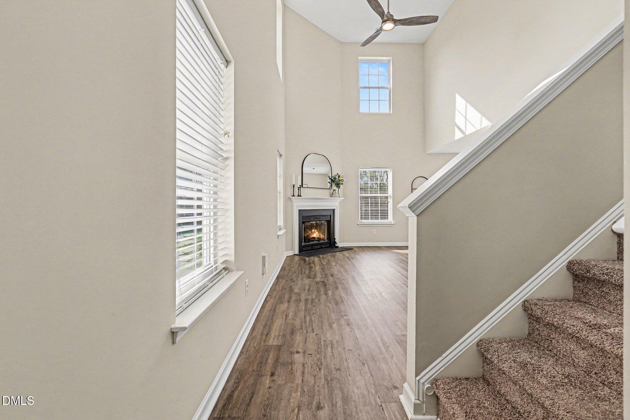 9904 Treymore Drive Raleigh, NC 27617 - Photo 3 of 33 a view of empty room with wooden floor and fan