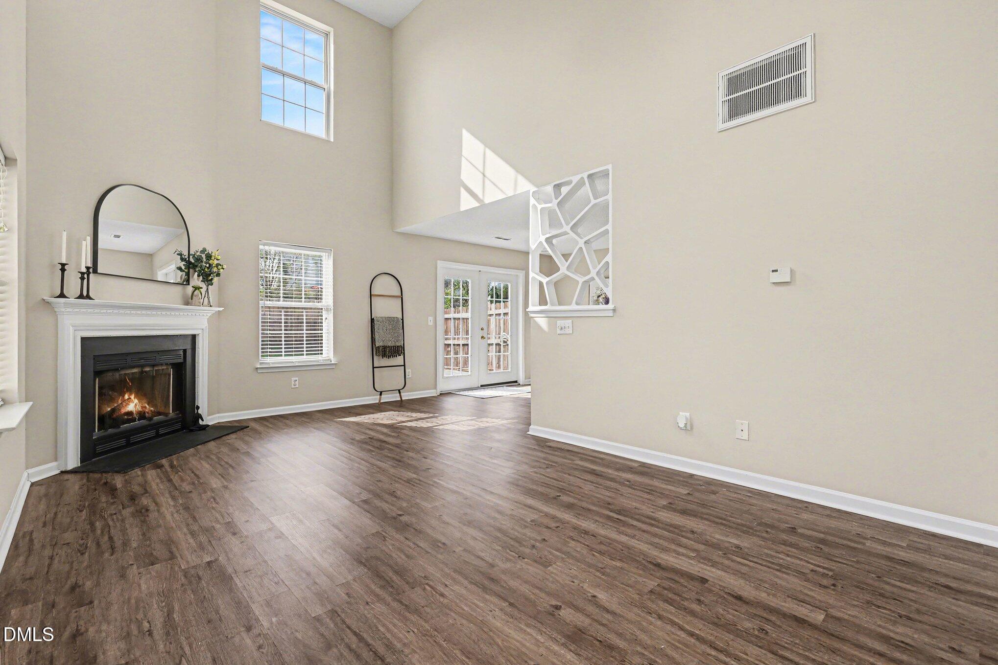 9904 Treymore Drive Raleigh, NC 27617 - Photo 4 of 33 a view of empty room with wooden floor and fireplace