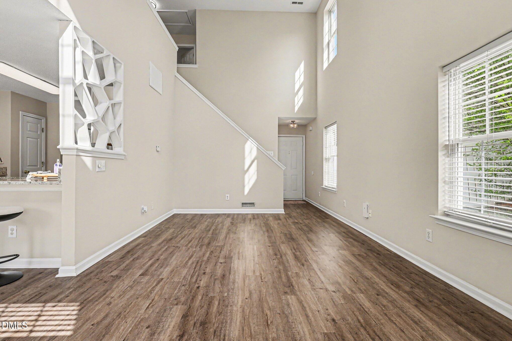 9904 Treymore Drive Raleigh, NC 27617 - Photo 5 of 33 wooden floor in an empty room with a window