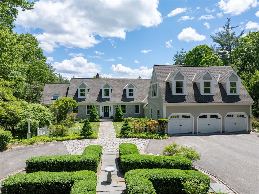 199 Bolton Road Harvard, MA 01451 - Photo 1 of 35 a front view of a house with a yard and garage
